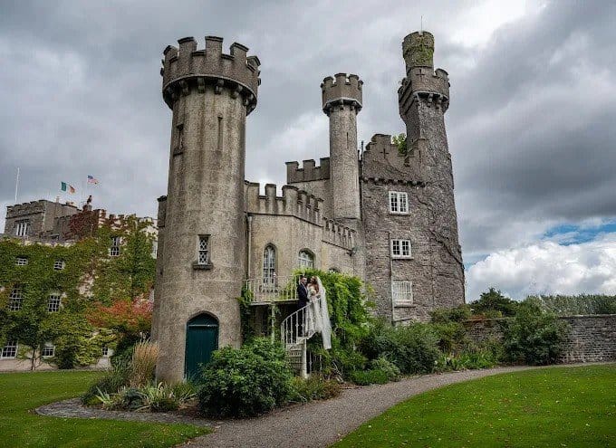The turrets of Luttrellstown Castle, with a bride and groom on the steps