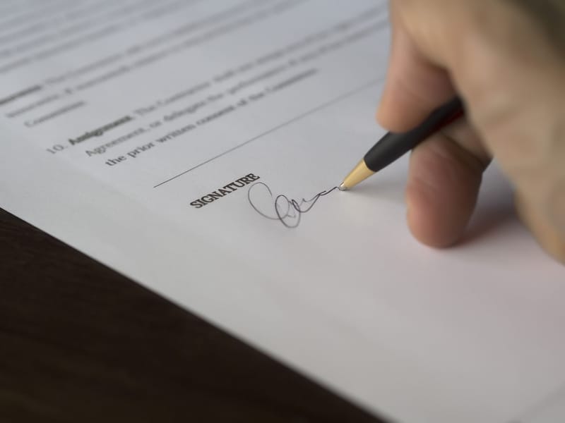 A pen signing a marriage document